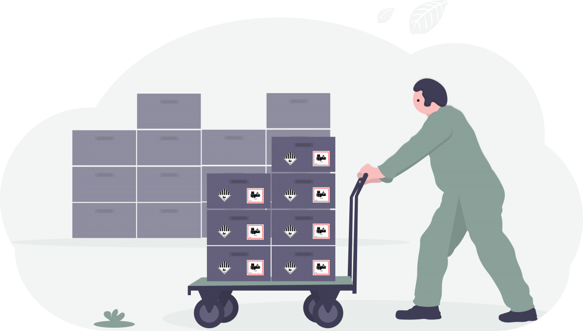 Person pushing a cart loaded with cardboard boxes labeled with hazardous materials symbols and handling precautions